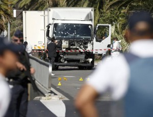 French police secure the area as the investigation continues at the scene near the heavy truck that ran into a crowd at high speed killing scores who were celebrating the Bastille Day July 14 national holiday on the Promenade des Anglais in Nice, France, July 15, 2016. REUTERS/Eric Gaillard