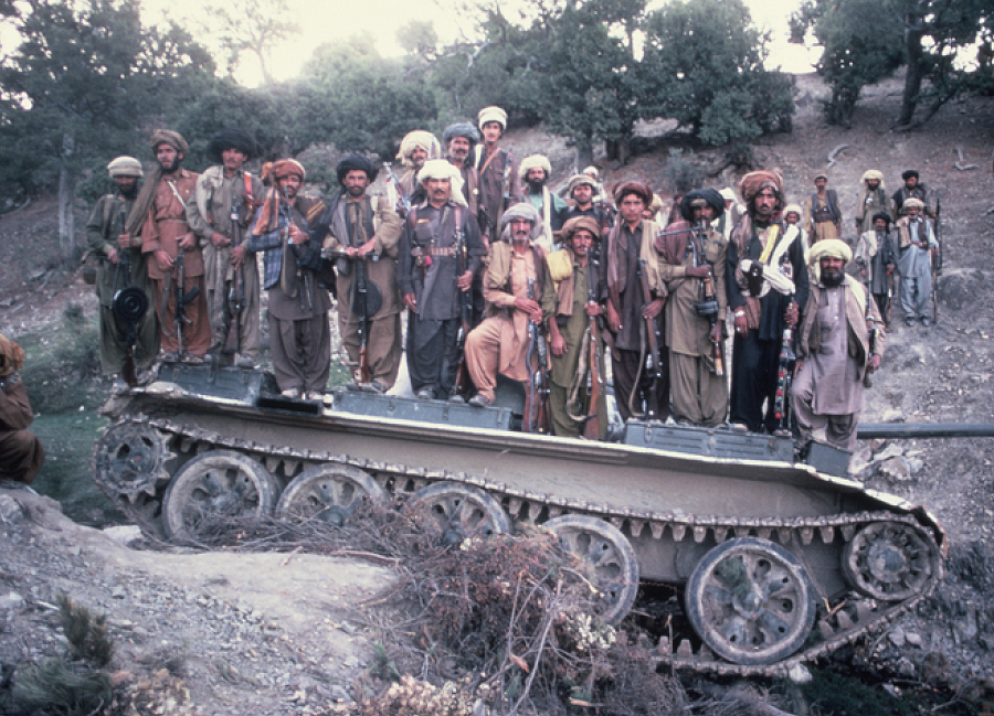 Afghan Mujahaddin with destroyed Russian T-62 tank, 1983 ©Jack Wheeler