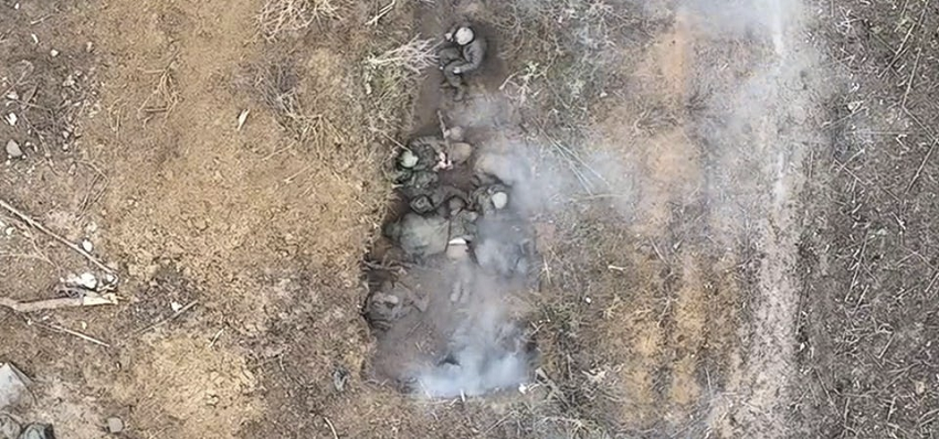 Russians too frozen to move in a trench as a drone bomb explodes among them